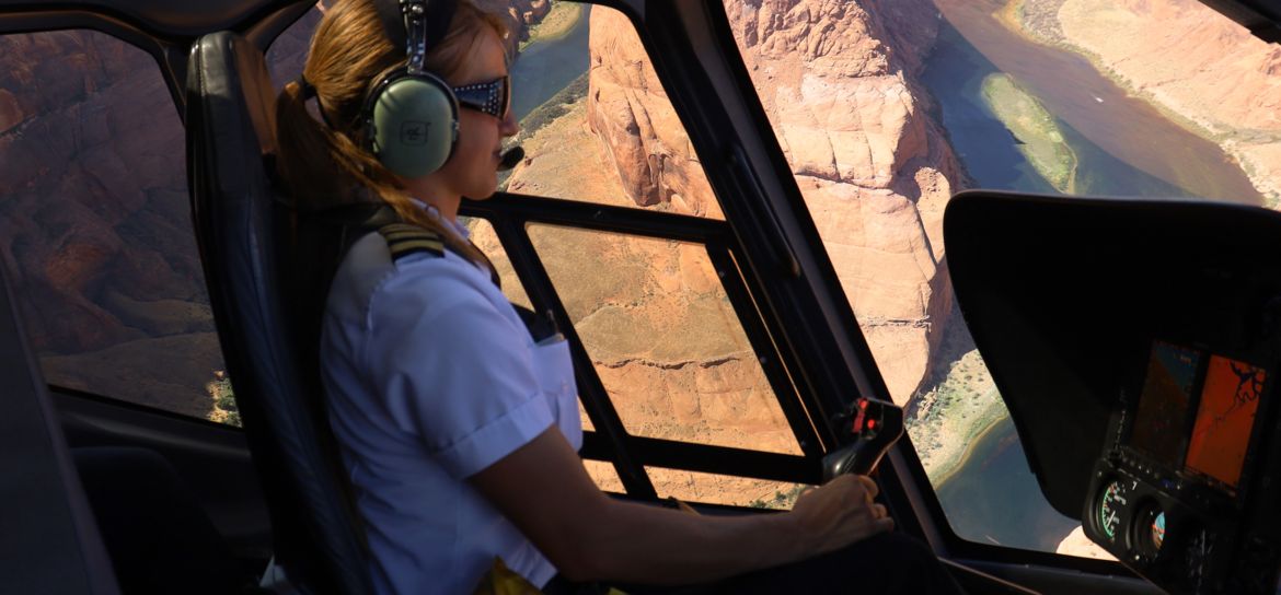 A helicopter pilot flying over Arizona Horseshoe Bend.