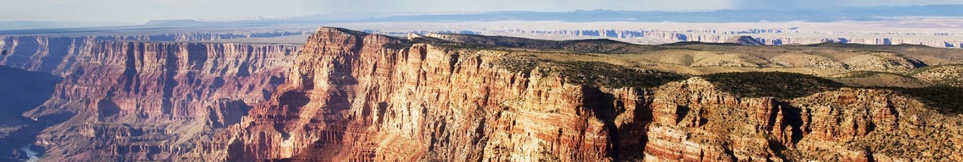the grand canyon and kaibab forest seen on a sunny day from a helicopter tour