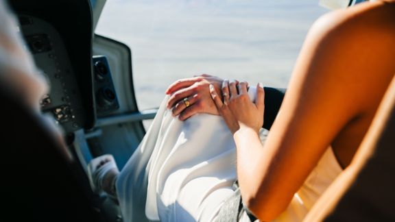 newlyweds' rings during a Las Vegas helicopter flight wedding ceremony