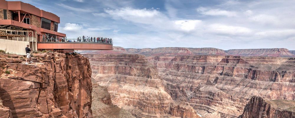 Visitors to the Grand Canyon West stand atop the Skywalk over the canyon's edge