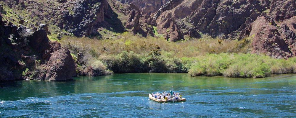 A rafting tour is floating along the Colorado River near Hoover Dam and the Black Canyon.