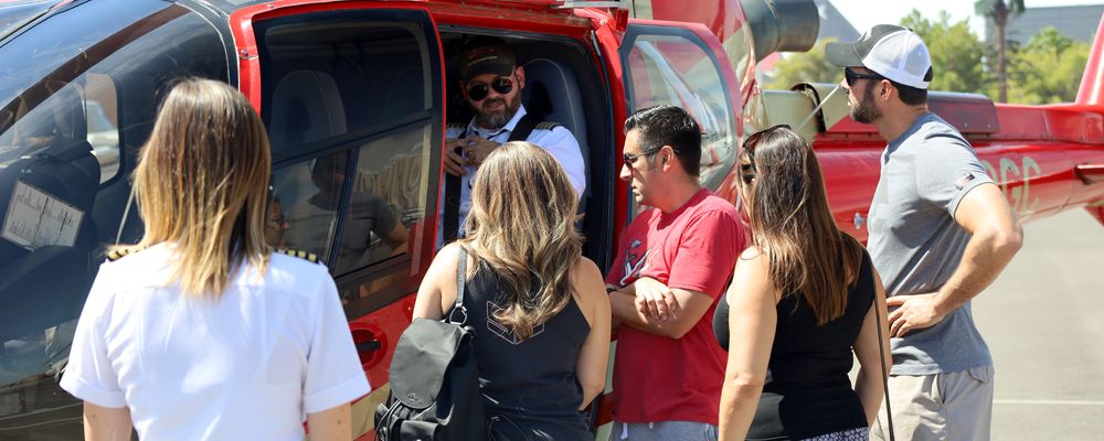 A group of passengers listen to the pilot before boarding their Grand Canyon helicopter tour