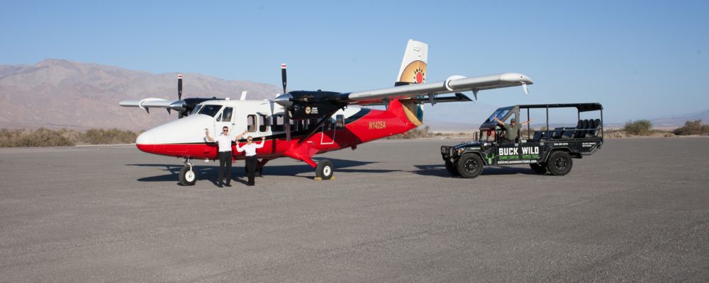 An airplane and Hummer parked on the runway, preparing for this exciting aerial and ground Grand Canyon combo tour.