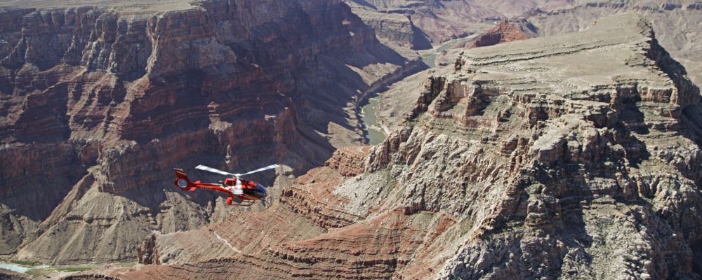 An EcoStar helicopter flies over the Grand Canyon North Rim