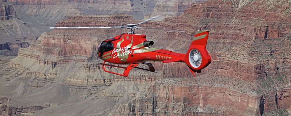 A helicopter flying above the Grand Canyon during tour.