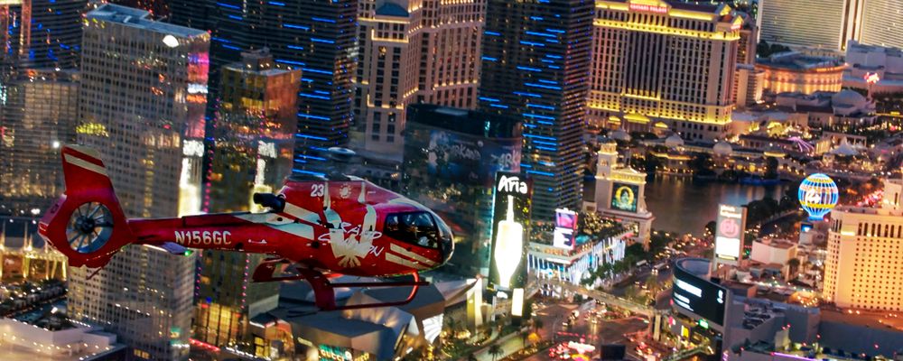 A Las Vegas helicopter tour flies over the Strip casinos at night