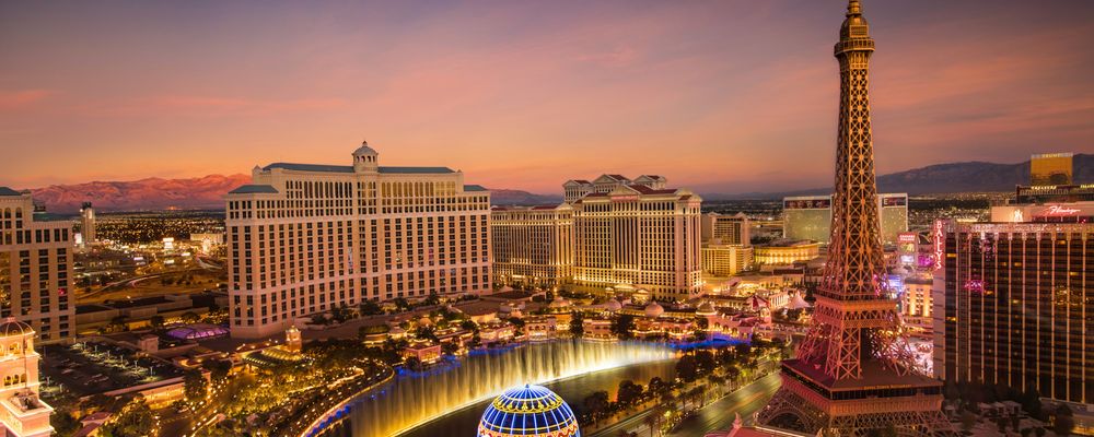 The Las Vegas Strip, particularly the Eiffel Tower and the Bellagio Fountains, seen at sunset
