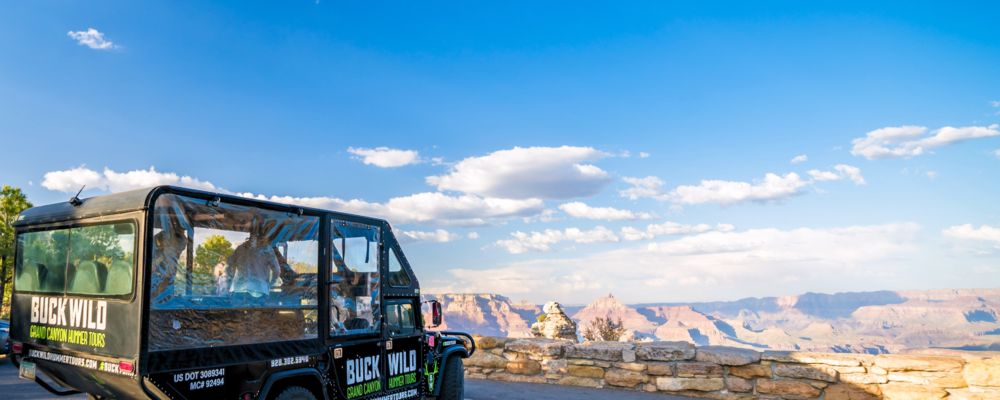 A Grand Canyon Hummer vehicle parked at the famous Duck on a Rock lookout point