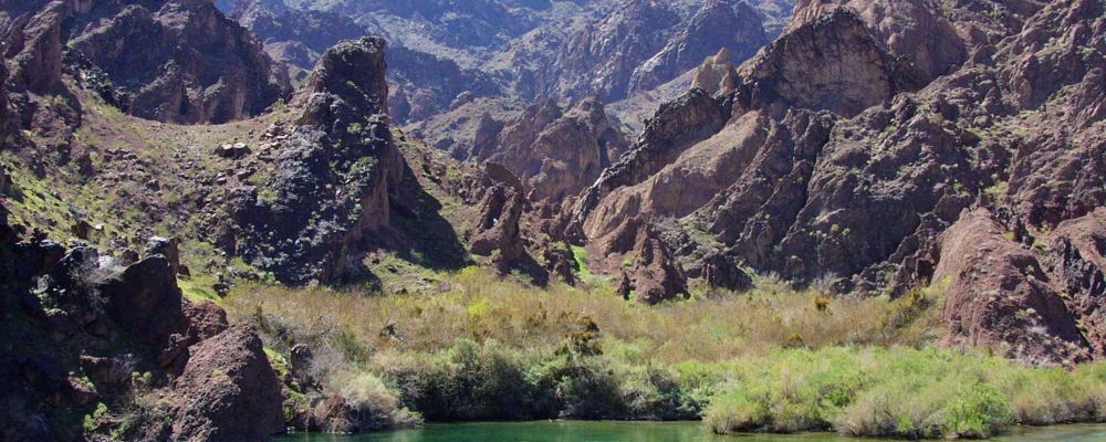 A rafting tour is floating along the Colorado River near Hoover Dam and the Black Canyon.