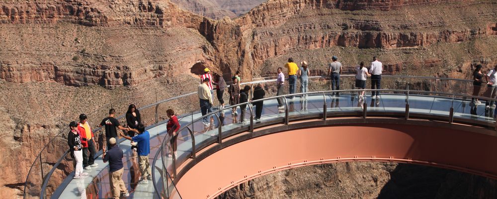 An aerial view Grand Canyon tourists wandering the glass floor of the Skywalk