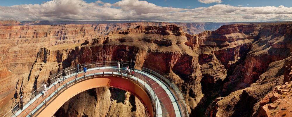 Guests are walking along the glass Skywalk Bridge at Grand Canyon West.
