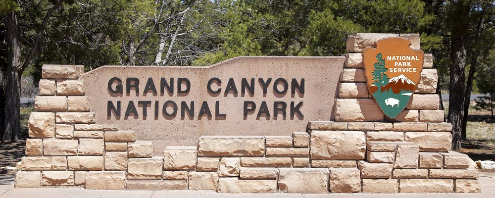 The stone welcome sign located at the entrance to the Grand Canyon National Park