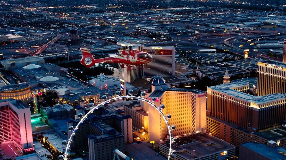 a helicopter tour flies over neon lights for a Las Vegas proposal