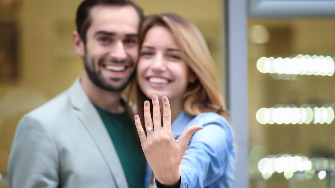 Happy couple showing engagment ring after Las Vegas proposal. 