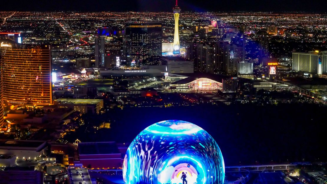 a helicopter flies past the MSG Sphere on the las vegas strip