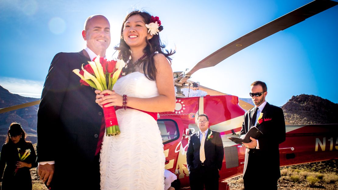 GCW Bride and Groom Holding Flowers Smiling couple during vow renewal on Grand Canyon tour