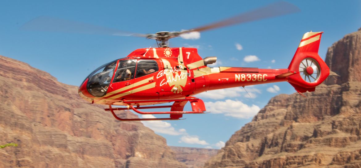 Grand Canyon Helicopter in Flight a helicopter tour departs from the Grand Canyon floor and flies through the ancient stone walls