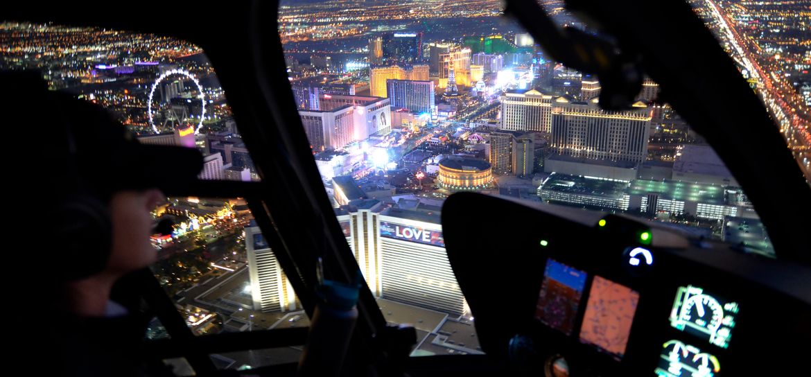 a Las Vegas Strip helicopter tour flying over the lit up casinos at night