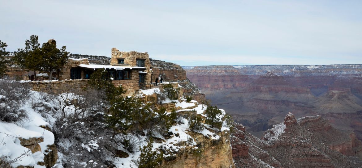 the historic Lookout Studio at the edge of the Grand Canyon coated in snow