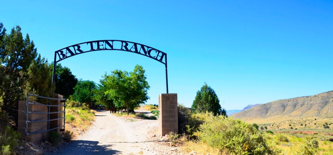the entrance to Bar 10 Ranch seen with a large sign and trees nearby