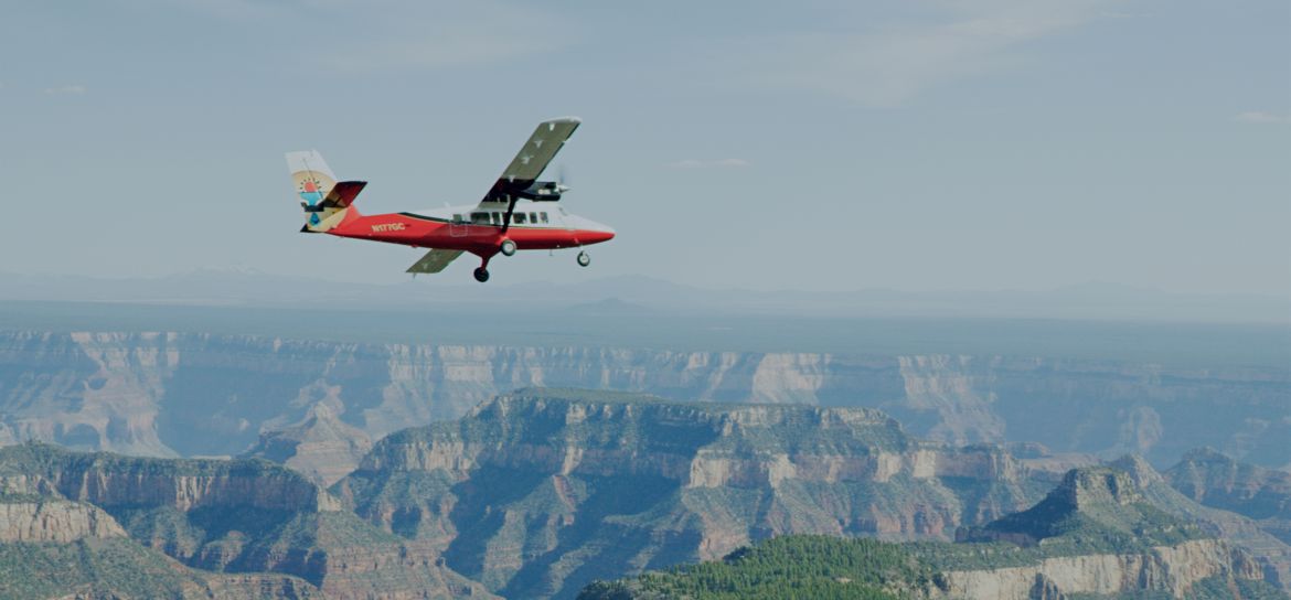 an airplane tour from Las Vegas flies over a lush green Grand Canyon landscape