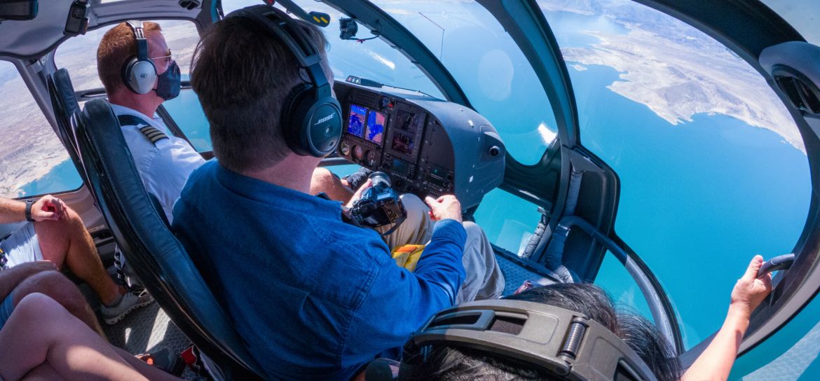 an interior view of a las vegas helicopter tour flying over the blue waters of Lake Mead