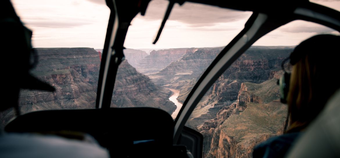 an interior view of a grand canyon helicopter tour flying over the colorado river