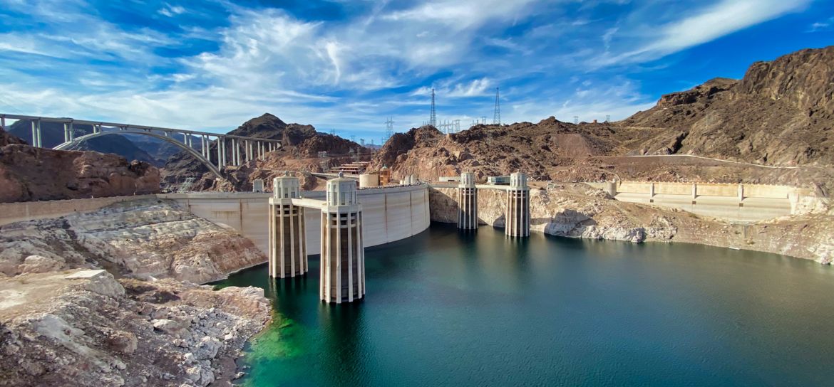 the blue water of the Colorado River with the Hoover Dam in the background