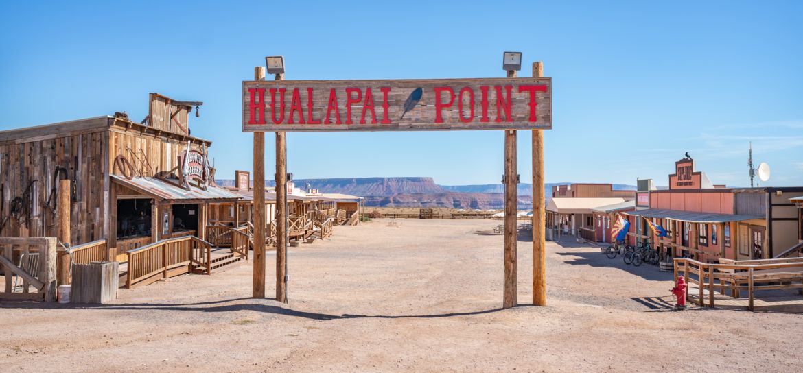 an Old West-style entry sign into Hualapai Point located at the Grand Canyon West
