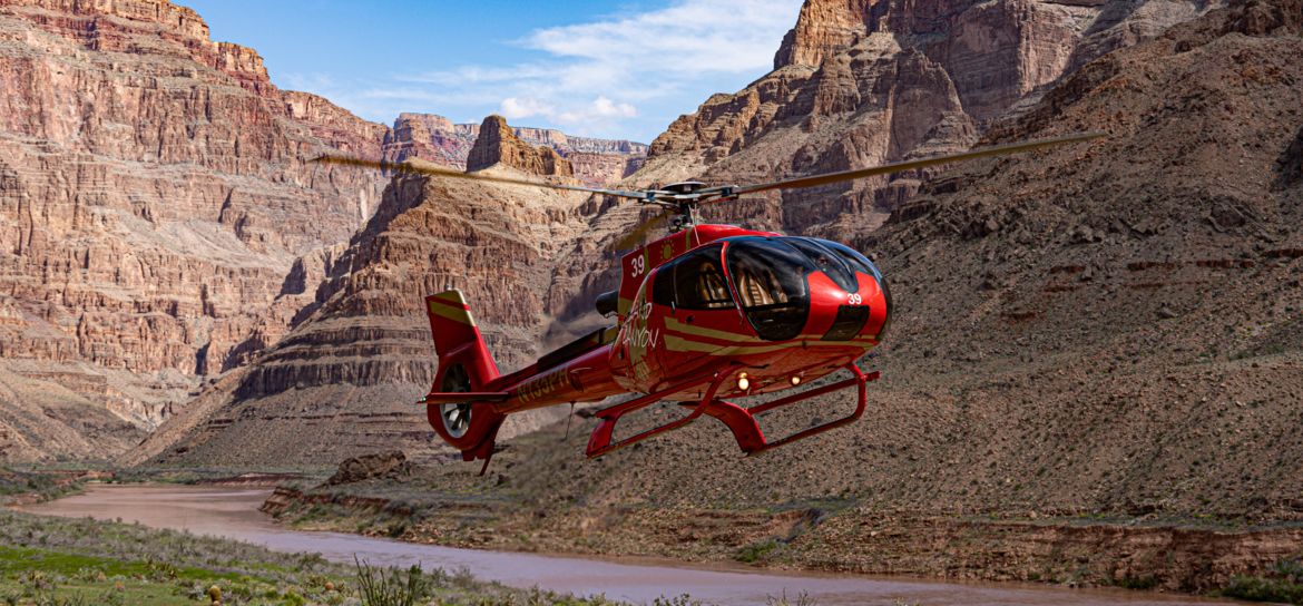 a Grand Canyon helicopter tour landed on the bottom of the West Rim takes flight