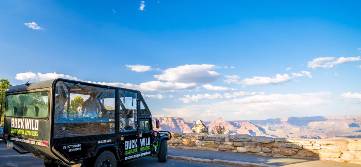 a military-style hummer vehicle parked at a Grand Canyon National Park lookout point