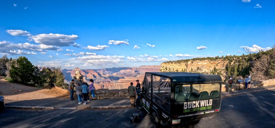 passengers aboard a Hummer ground excursion explore a Grand Canyon South Rim lookout point