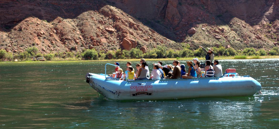grand canyon visitors ride an inflatable raft down the colorado river