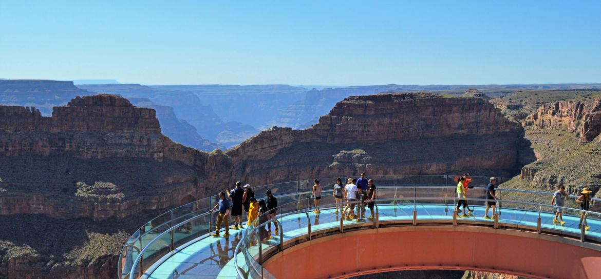 visitors to the Grand Canyon West stand atop the Skywalk glass bridge