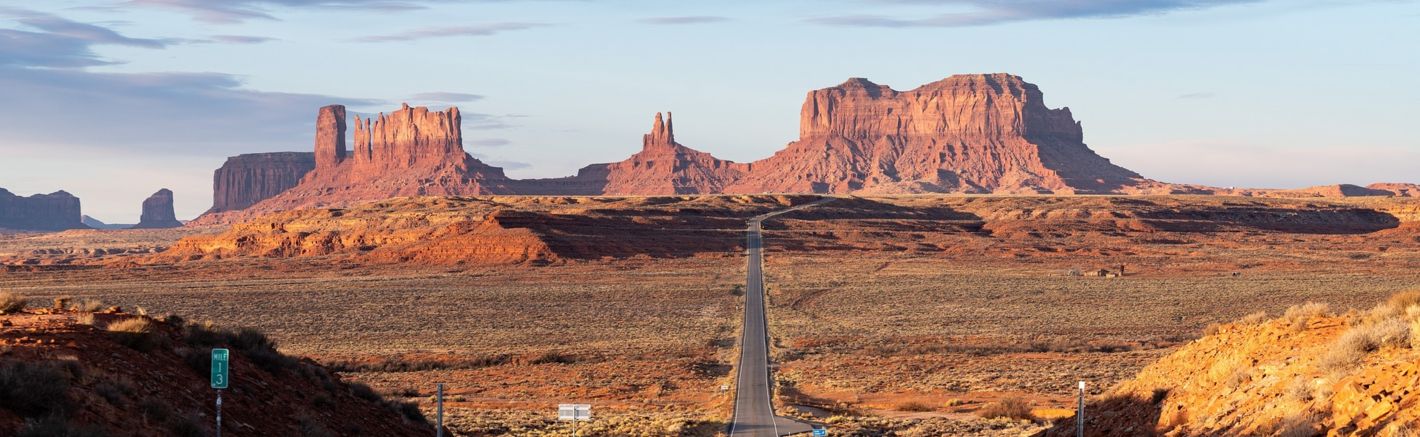 a Monument Valley landscape split in half by a highway road