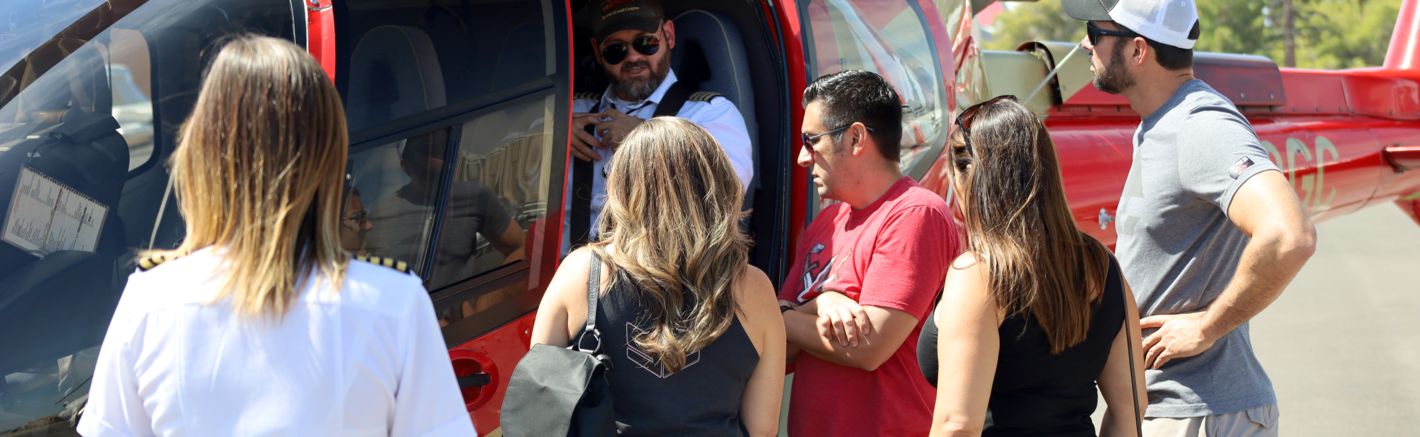 Tour group boarding a papillon helicopter for one of the best day trips from las vegas
