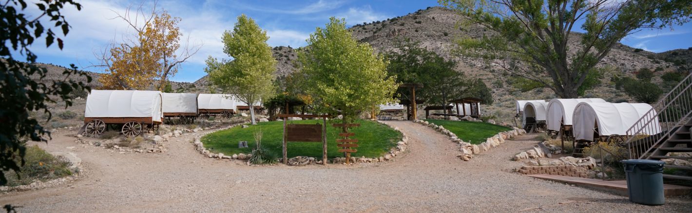 Bar 10 Ranch exterior with covered wagons scattered across the landscape