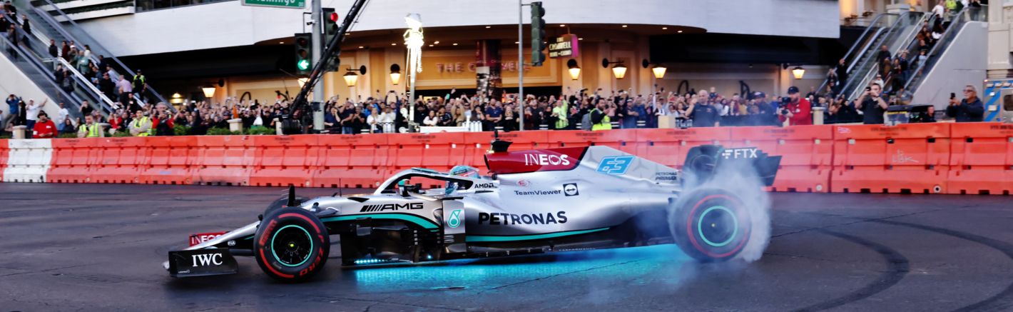 Race car driver burning rubber at the Las Vegas Grand Prix Launch Party.