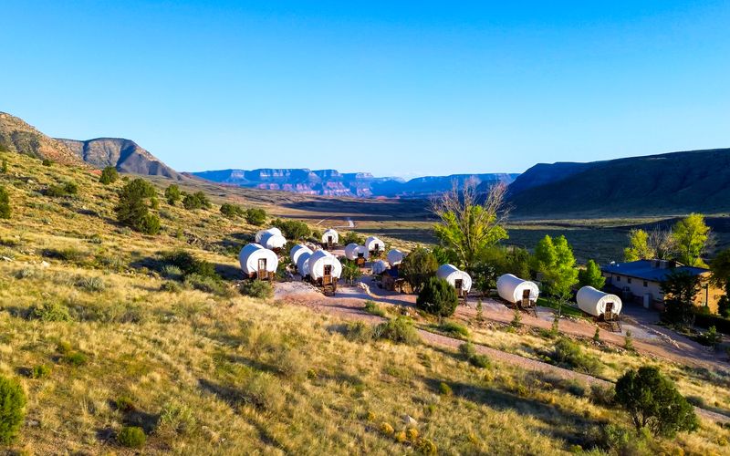 RS16827_ATV-and-UTV-riders-and-passengers-parked-on-edge-of-grand-canyon-north-rim-from-bar-10-ranch-blue-skies