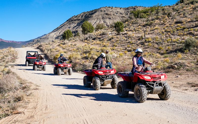 RS12376_DSC4664EDIT-atv-and-utv-parked-on-edge-of-grand-canyon-north-rim-blue-skys