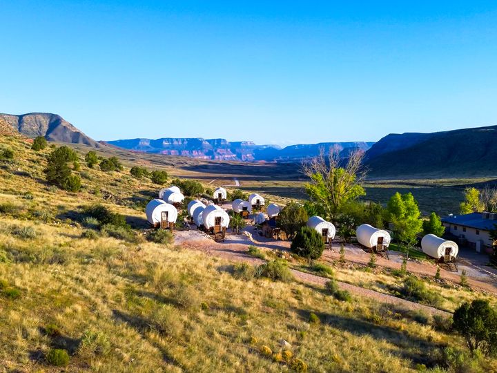 RS16827_ATV-and-UTV-riders-and-passengers-parked-on-edge-of-grand-canyon-north-rim-from-bar-10-ranch-blue-skies