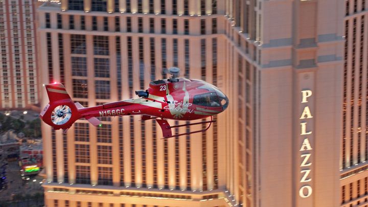 RS14183_Clip2-red-ec-130-flying-over-las-vegas-past-palazzo