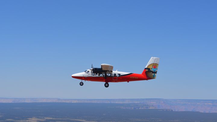 A Twin Otter plane flying over Grand Canyon South Rim