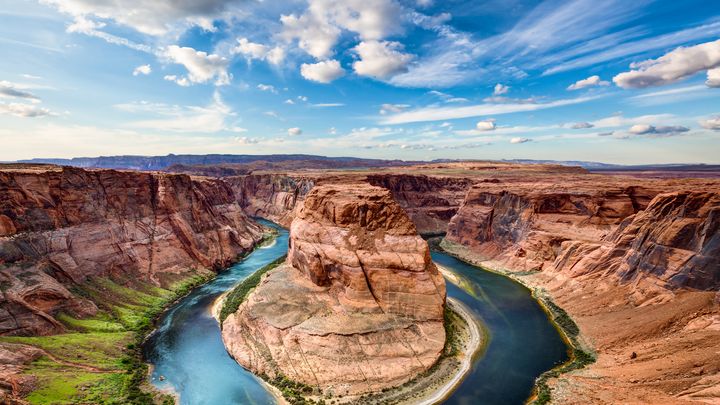 RS8113_shutterstock_image-of-horseshoe-bend-spring-time-green-river-banks-and-partially-cloudy-skies