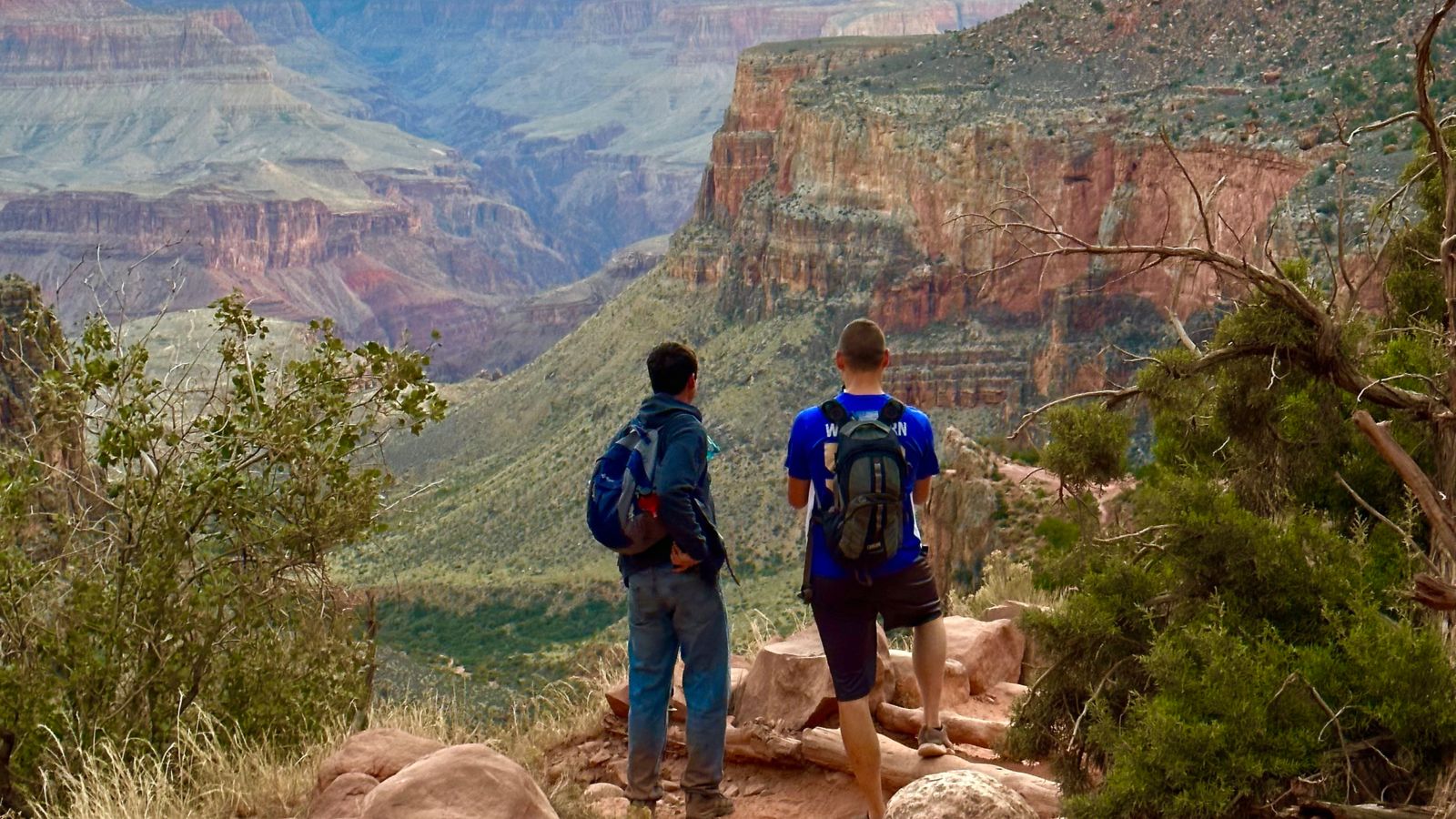 Two hikers on Grandview Trail watch the sunset at the Grand Canyon