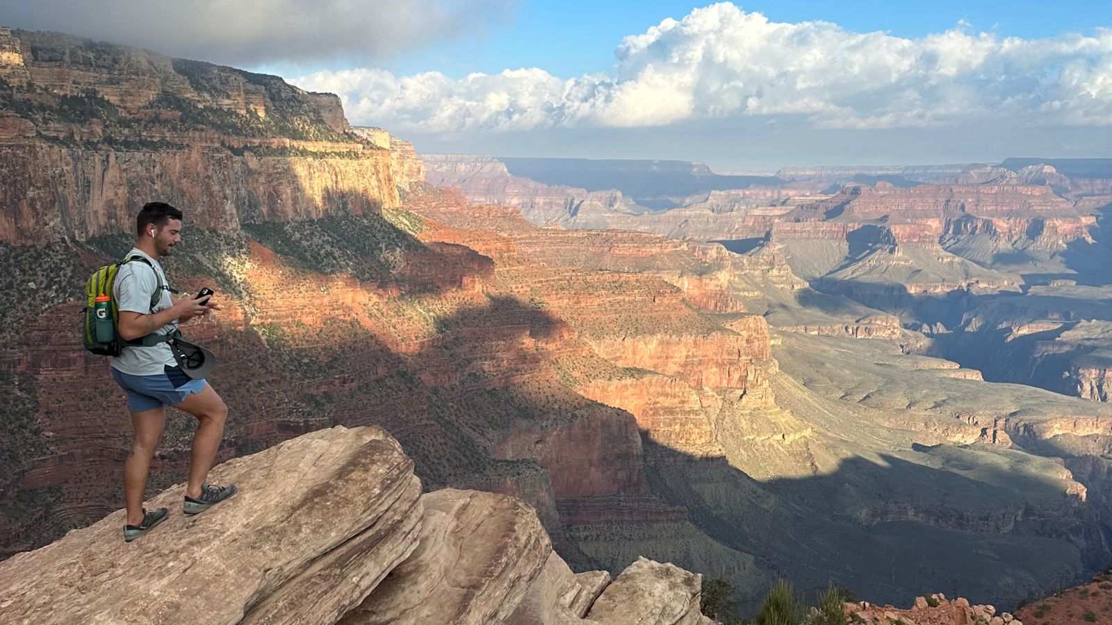 a hiker stands on Grandview Trail and looks out at the Grand Canyon scenery