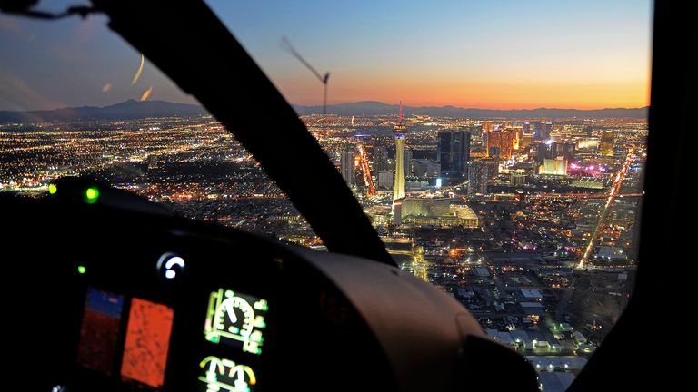 a Las Vegas helicopter tour flies toward the Strip with the Stratosphere Tower in the foreground