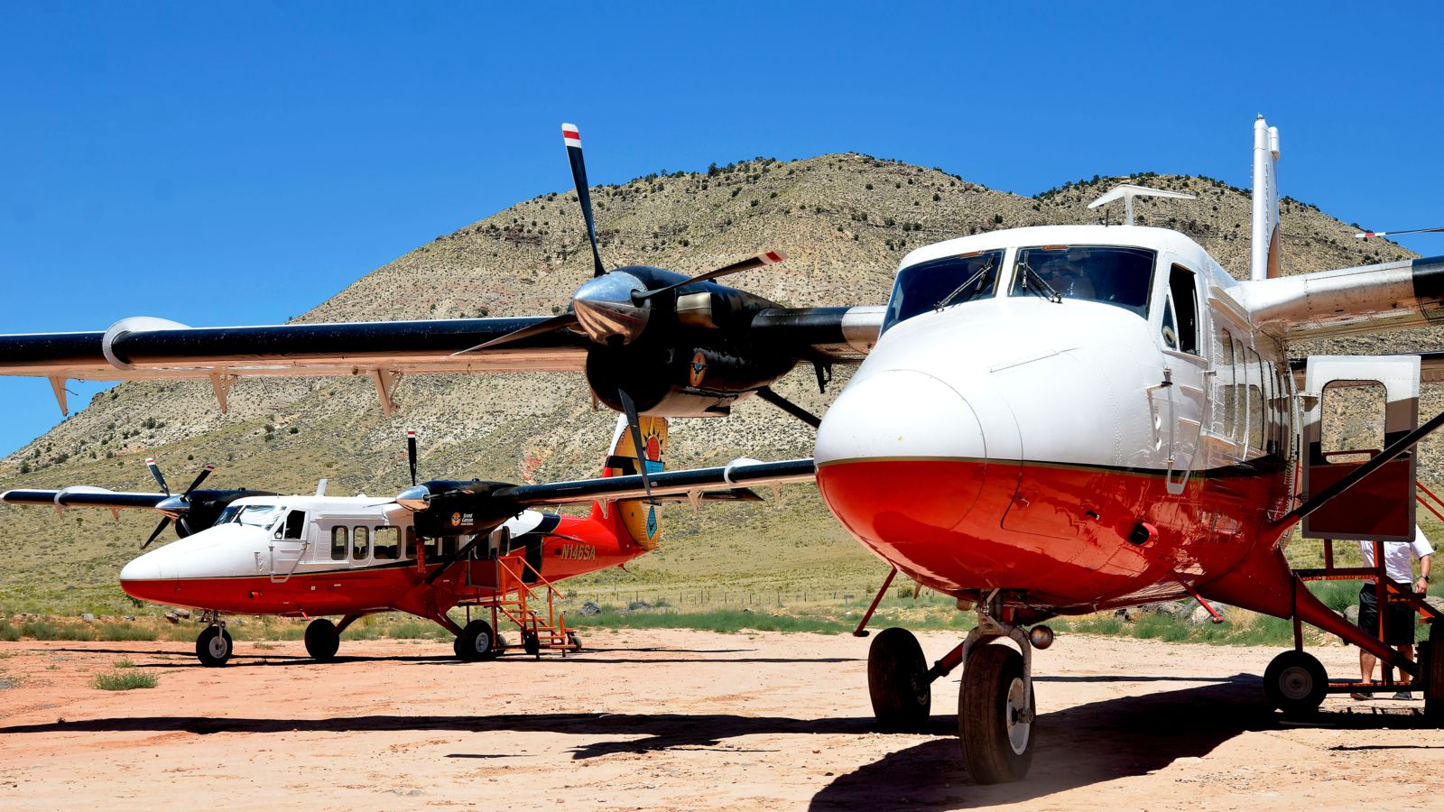 Two sightseeing airplanes parked at Bar 10 Ranch
