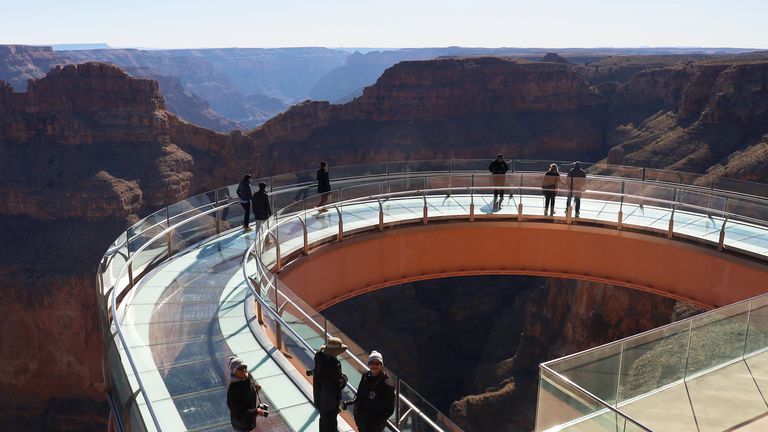 View of people on the Skywalk glass bridge with Eagle Point in the background