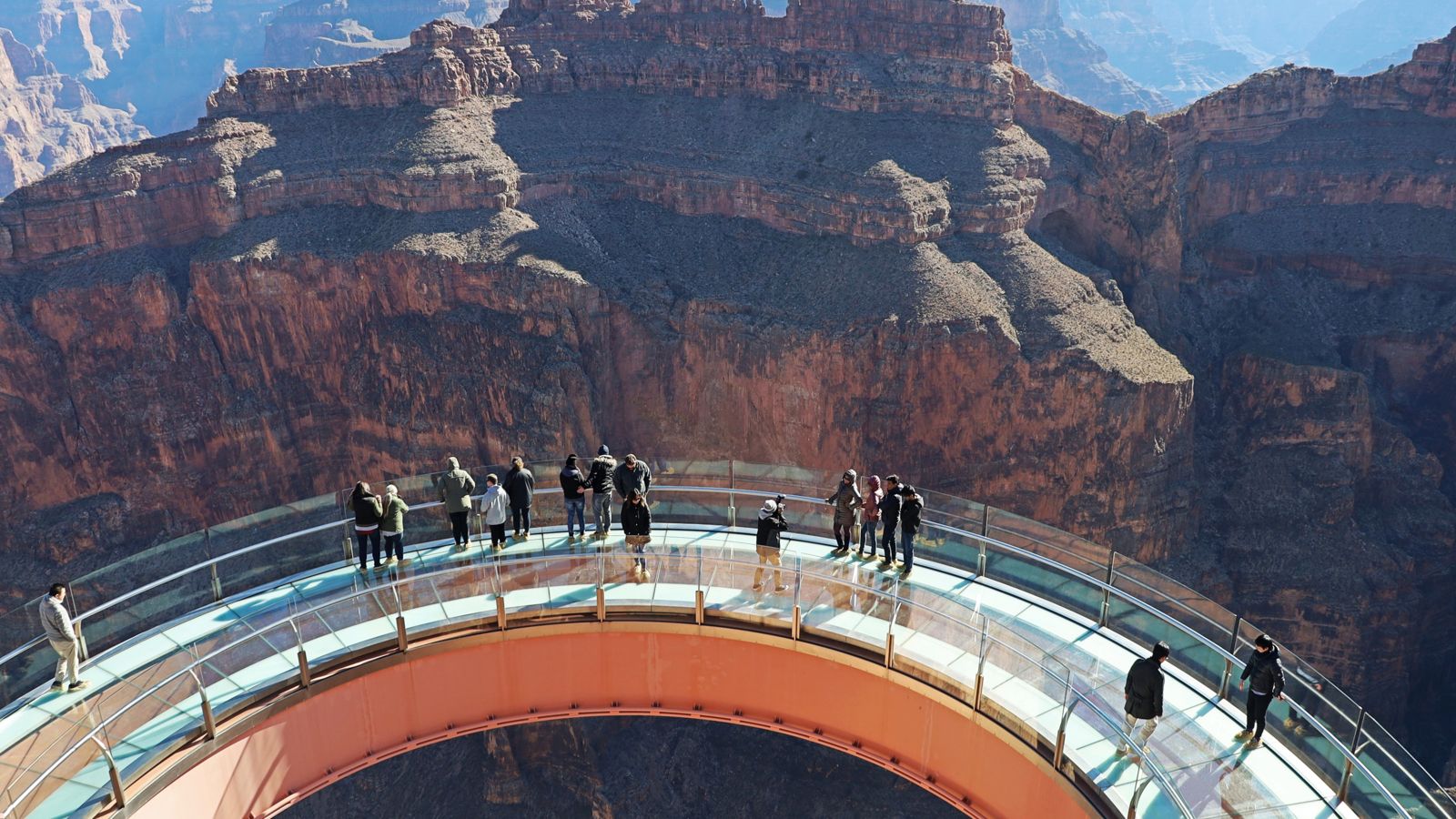 View of the Grand Canyon Skywalk from above with people enjoying the views of Grand Canyon West Rim on a bright sunny day